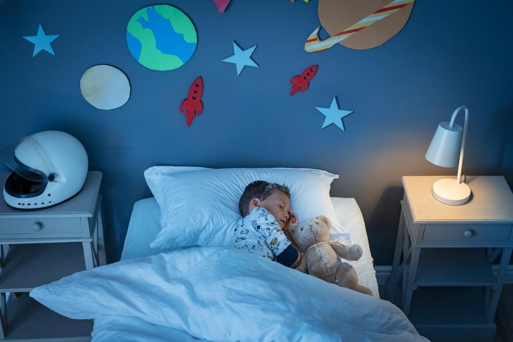 Little boy sleeping soundly in his bed.