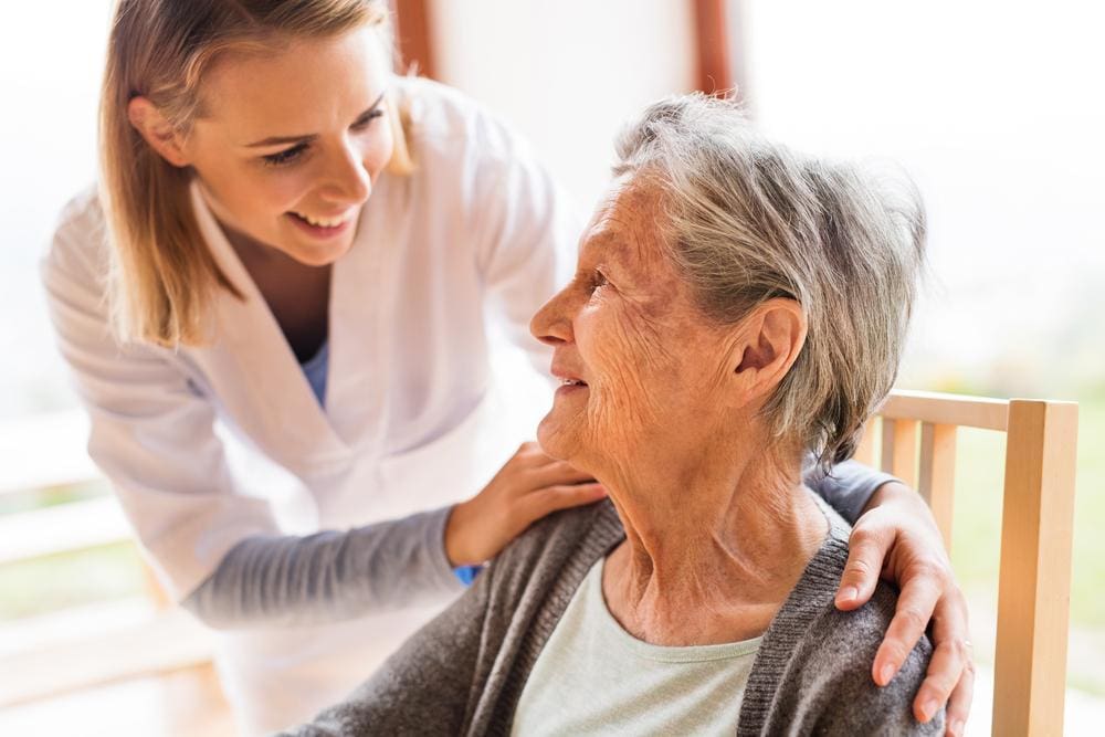 Home health worker visiting an older woman.