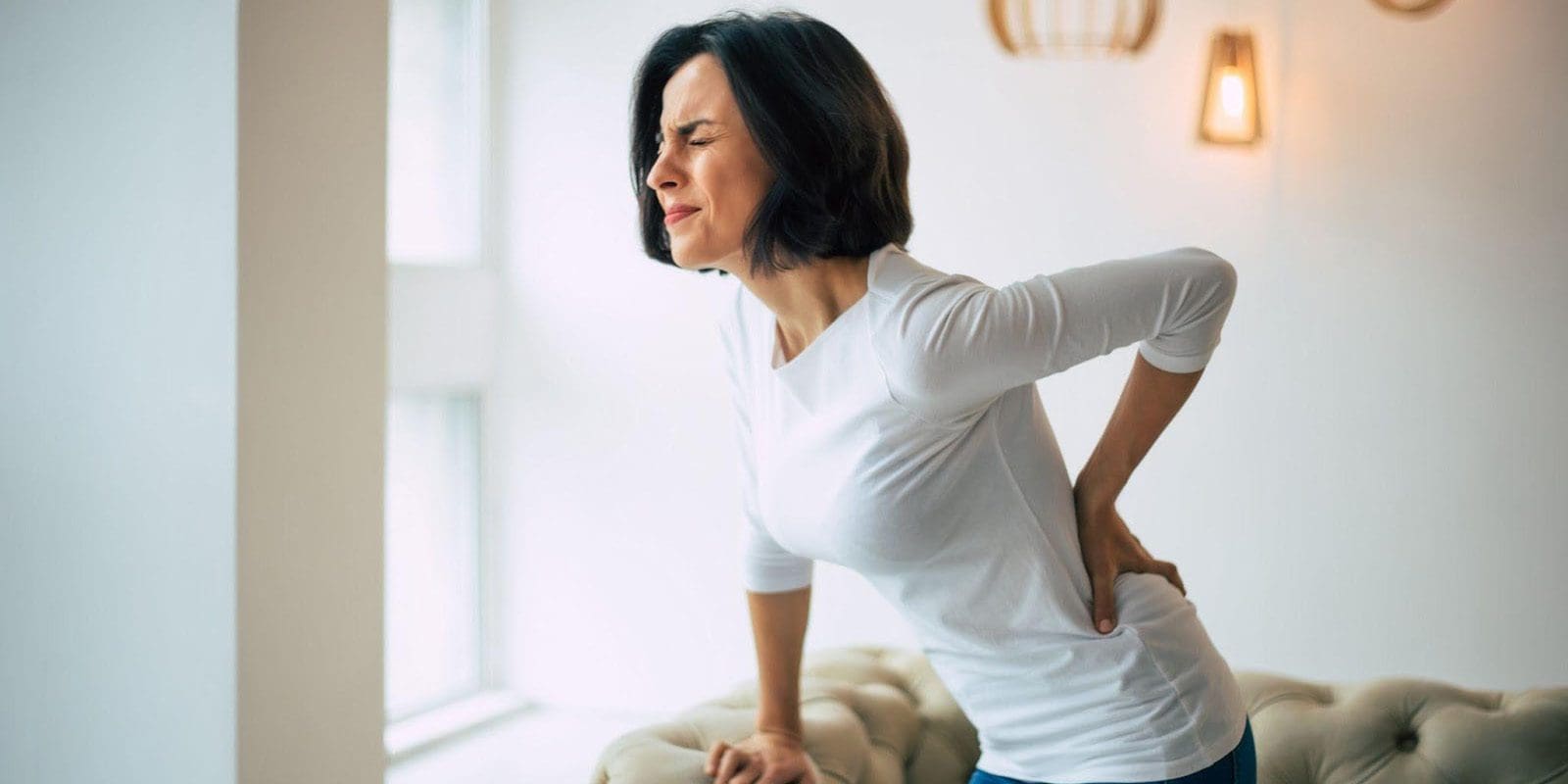 A woman suffering from Spondylolisthesis pain.