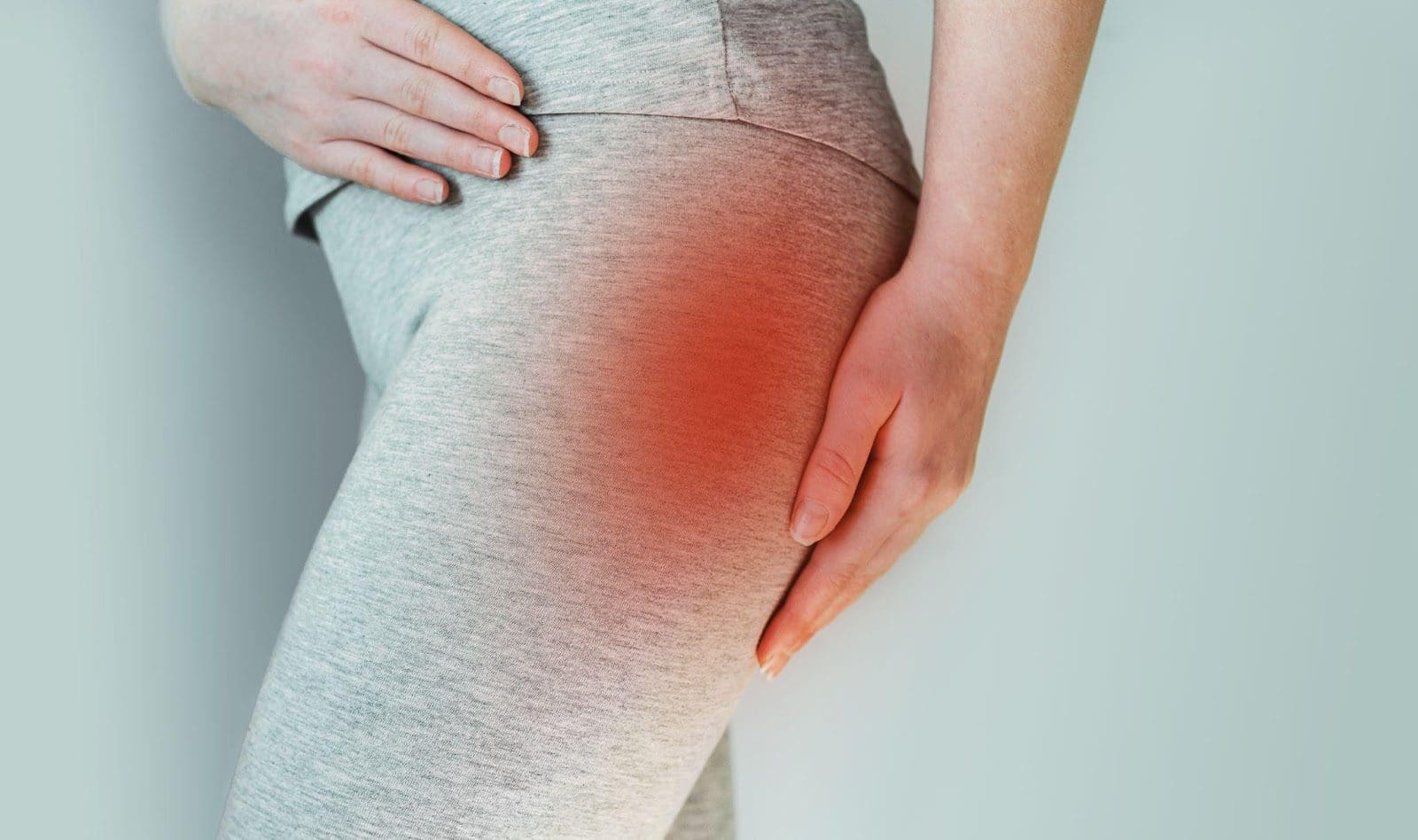Close-up of a woman's right hip, glowing red to indicate pain from an annular tear.