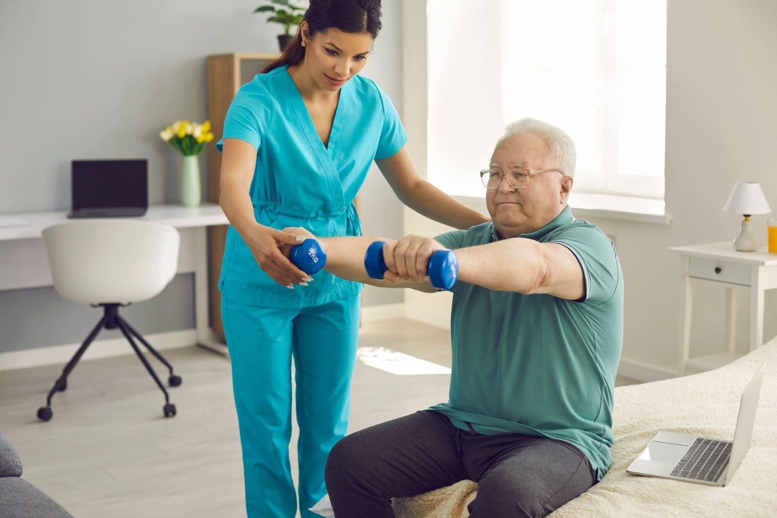 A chiropractor helps an older man with arm exercises using light dumbbells.